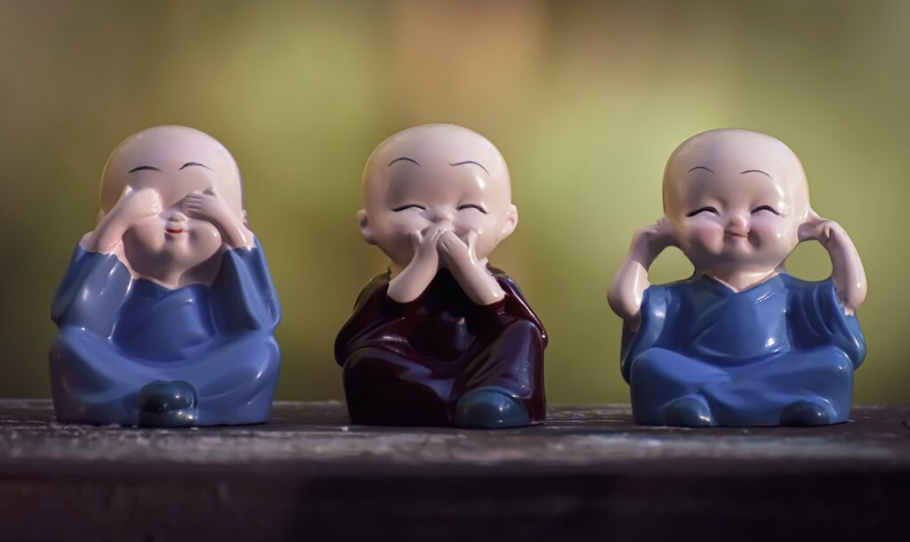 tres figuras sentadas, calvas una tapándose los ojos, otra la boca y otra los oídos