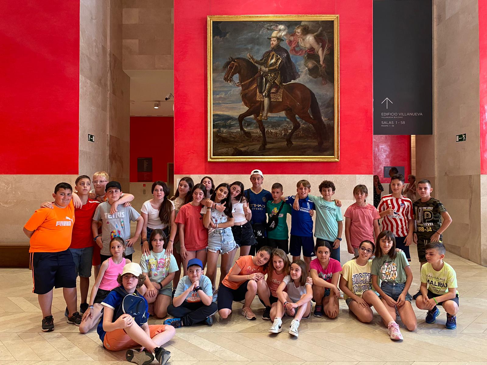 Sala del museo del Prado de Madrid de fondo un cuadro de Felipe II a caballo de Rubens y en primer plano un viaje de estudiantes